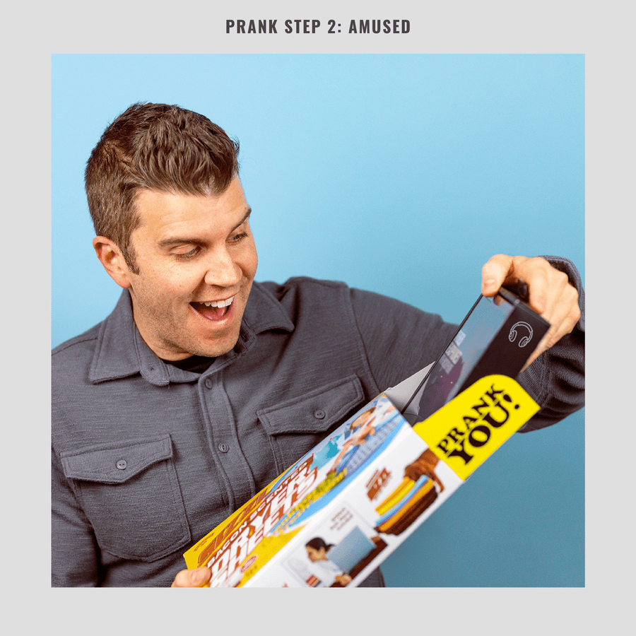 Man unboxing a gift from a Prank-o joke box